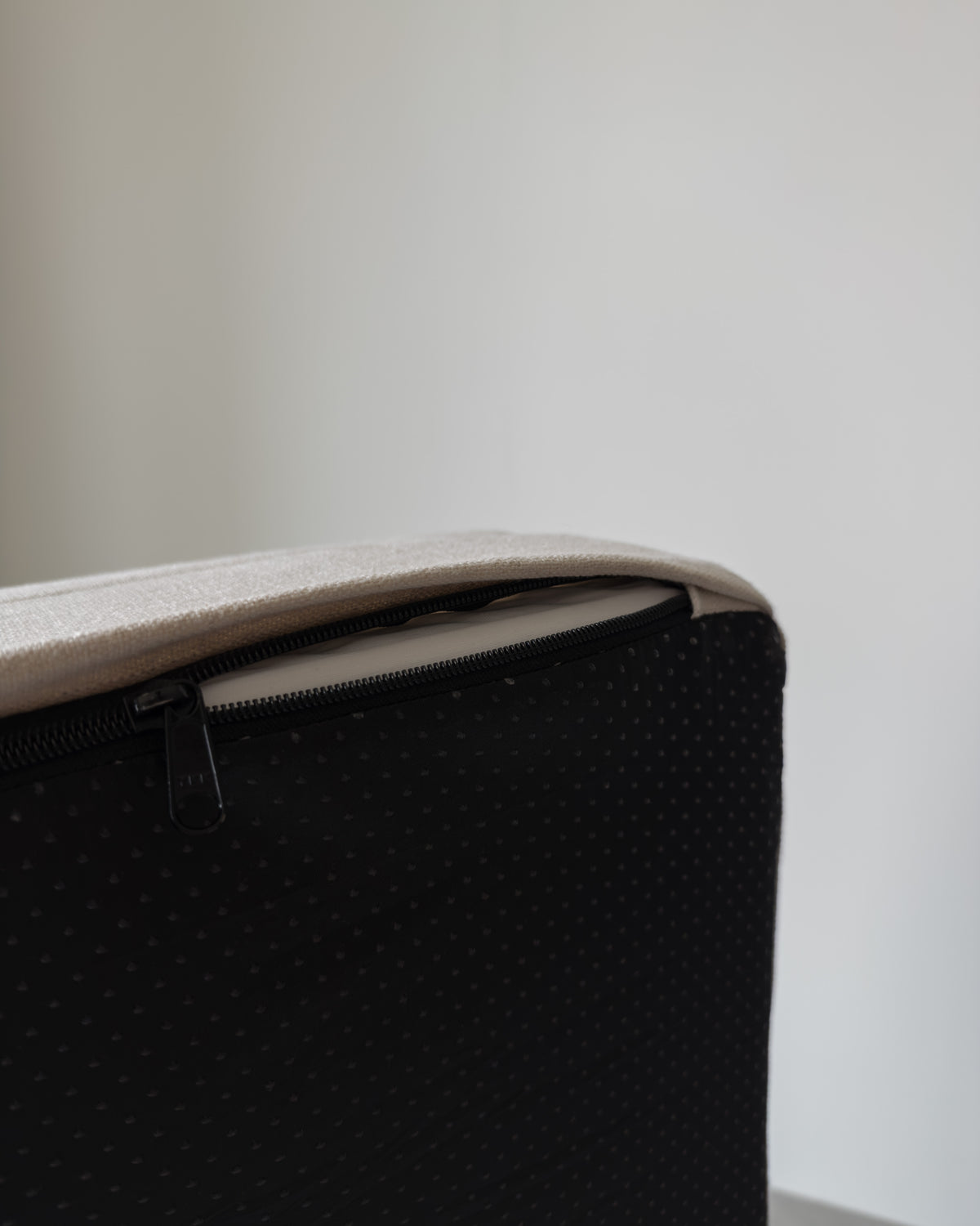 The cover unzipped at the corner, showing the zip and the non-slip base